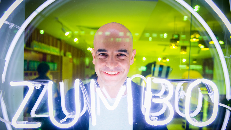 Adriano Zumbo next to neon lights