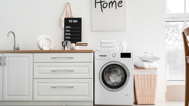 A kitchen with a washing machine. 