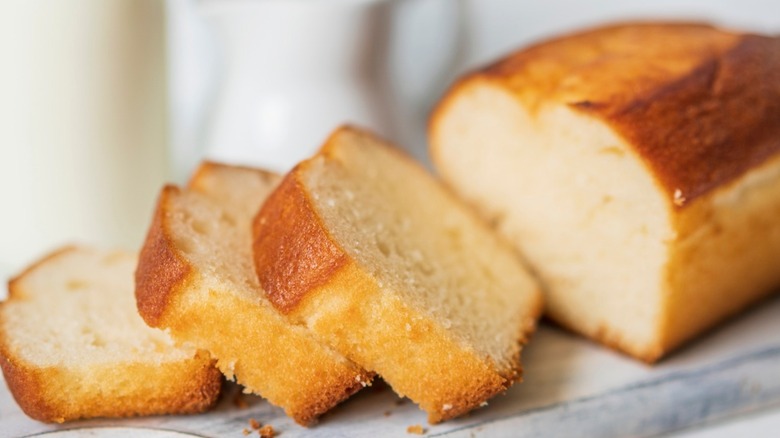 A golden poundcake loaf with slices cut