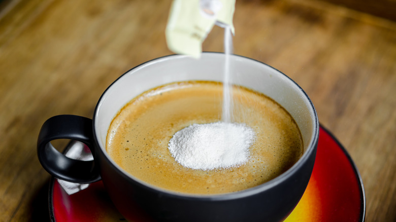 Powdered coffee creamer in a cup of coffee