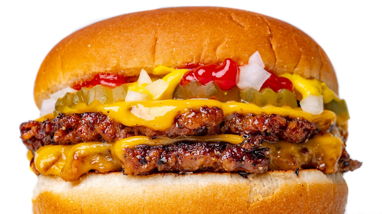 Side profile photo of a cheeseburger
