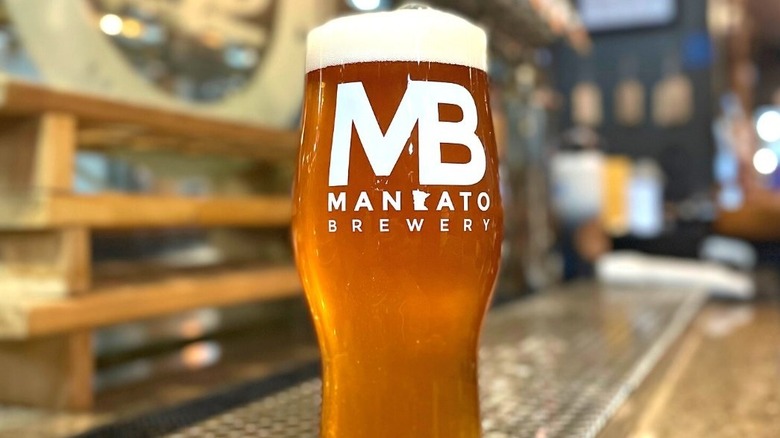 Mankato Brewery logo on full pint glass