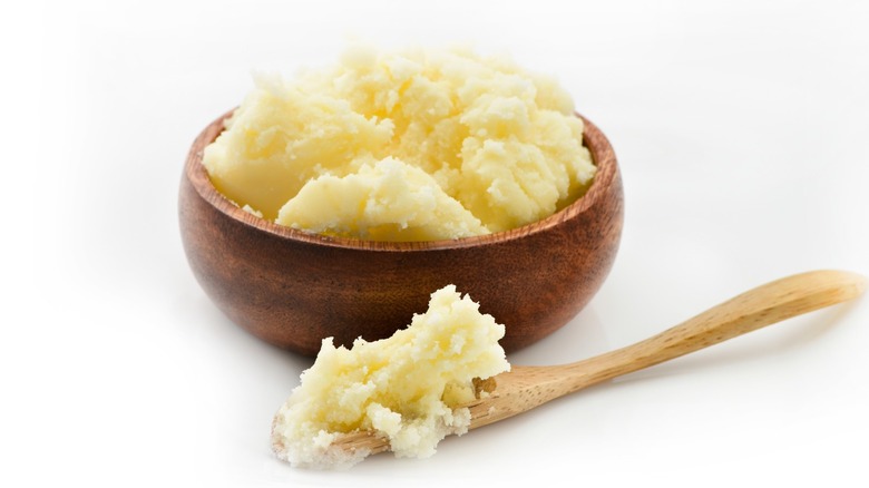 ghee in wooden bowl with wooden spoon