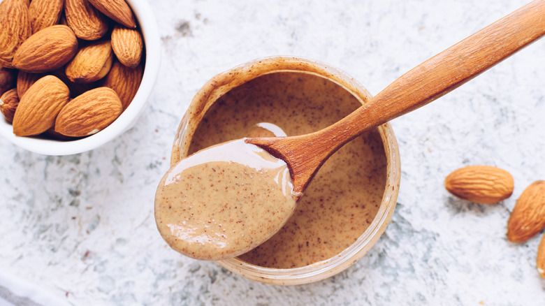 Wooden spoon in almond butter 
