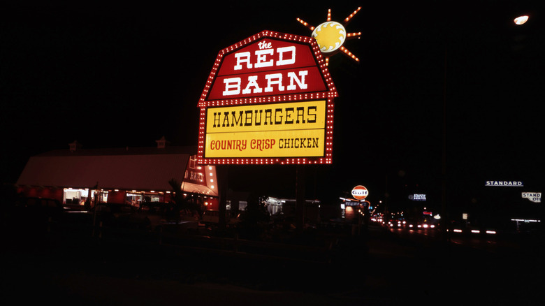 A night shot of a Red Barn Burger building.