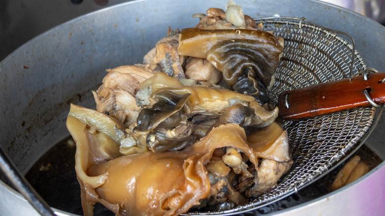 Turtle meat on a metal strainer