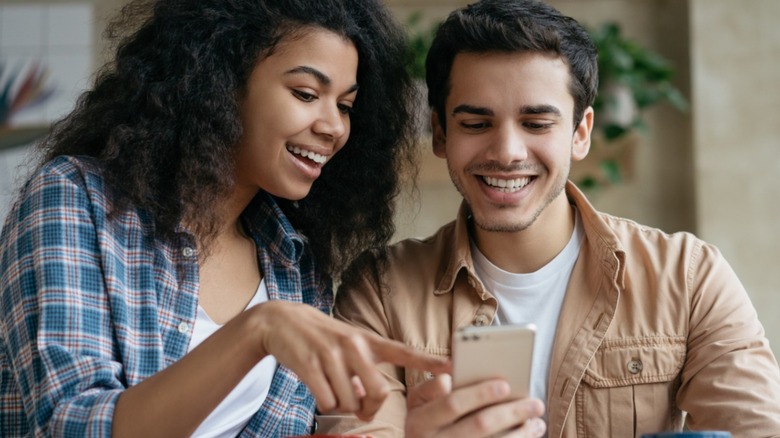 People laughing at phone