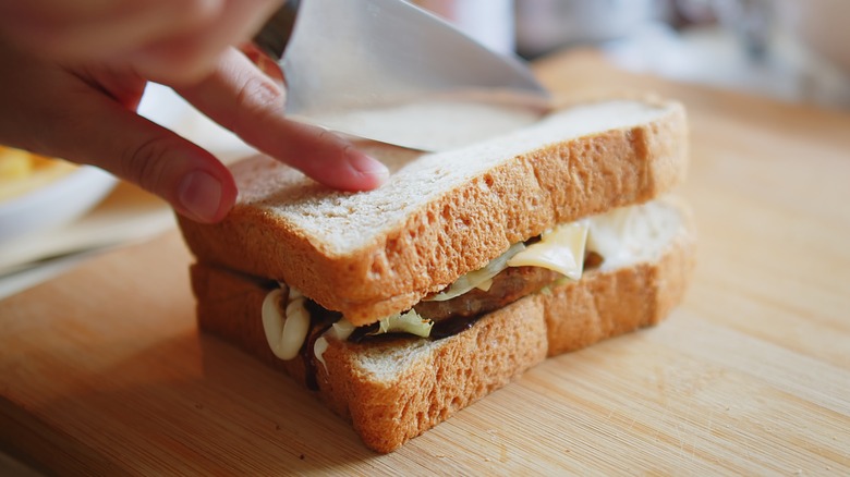 Slicing sandwich diagonally with knife