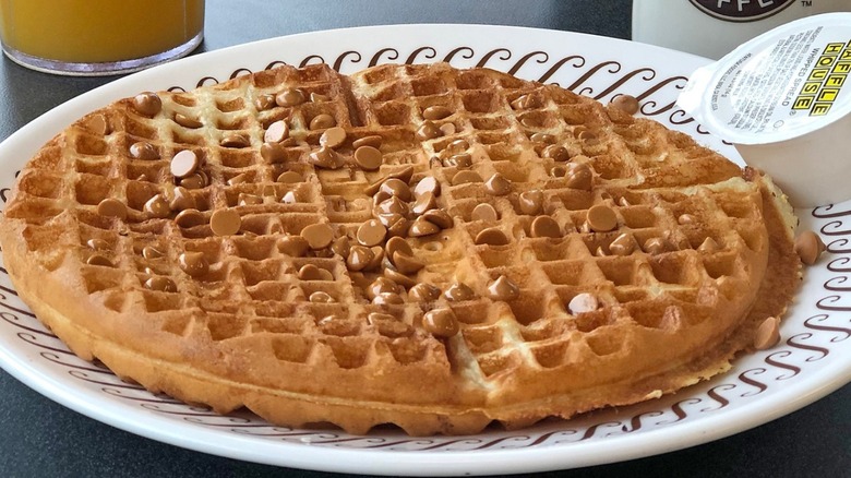 Fruity Pebbles over a waffle with chocolate sauce 