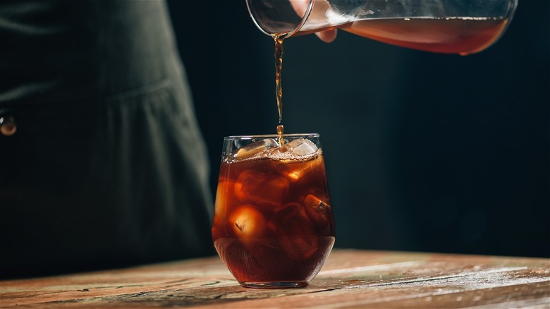 Pouring cold brew over ice