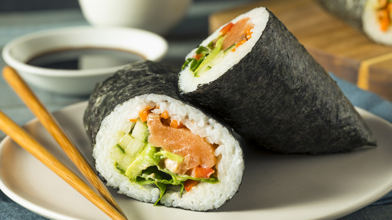 sushi burrito with chopsticks