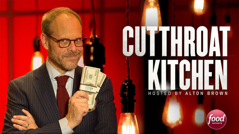 Cutthroat Kitchen promo shot with Alton Brown holding cash