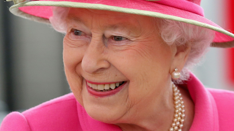 Queen Elizabeth II wearing pink hat and jacket