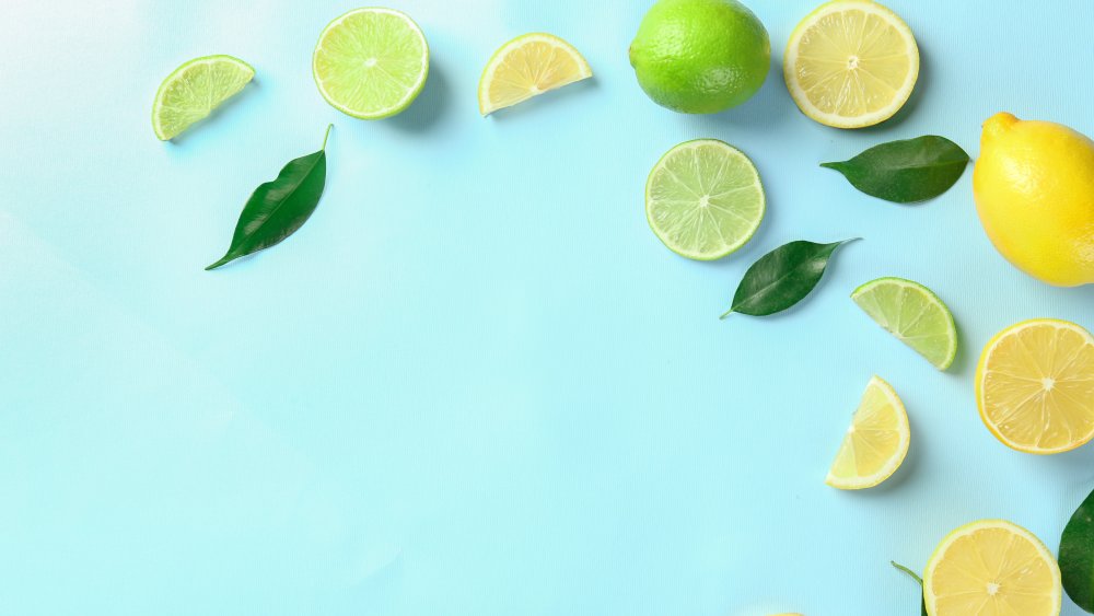 lemons and limes against a light blue background