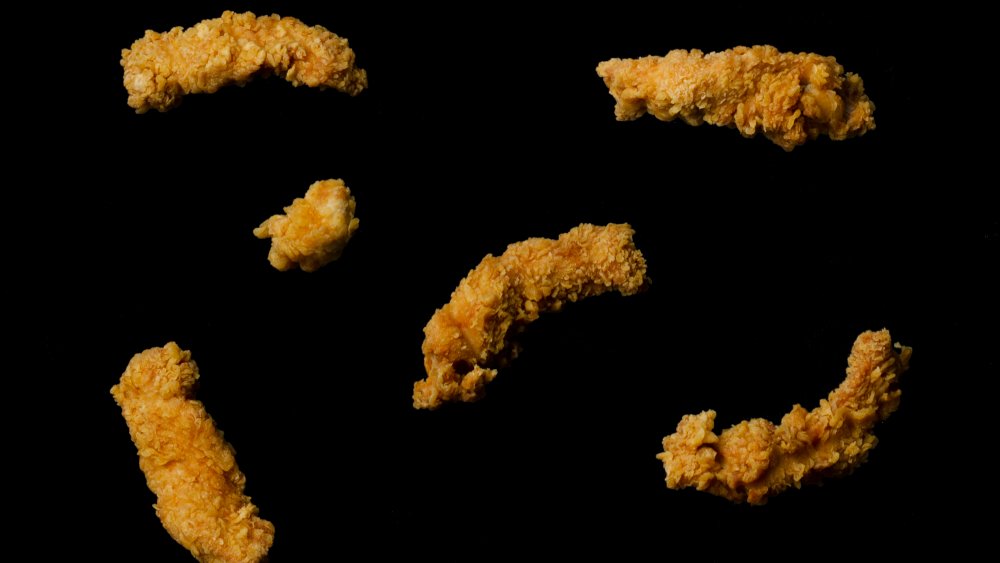 Chicken tenders floating in black space