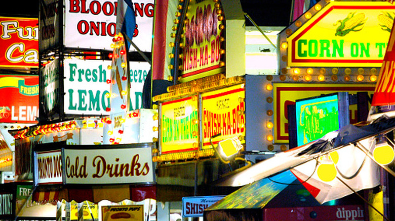 The bright lights of food vendors at a fair