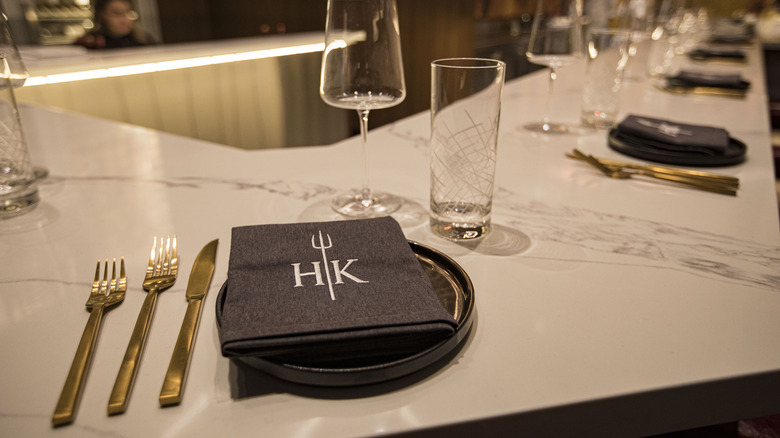 The Hell's Kitchen symbol on napkin place setting