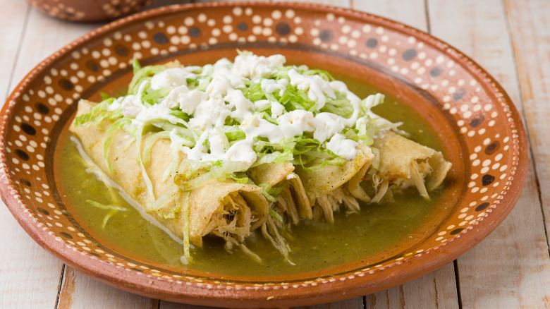 Green chicken enchiladas in dish