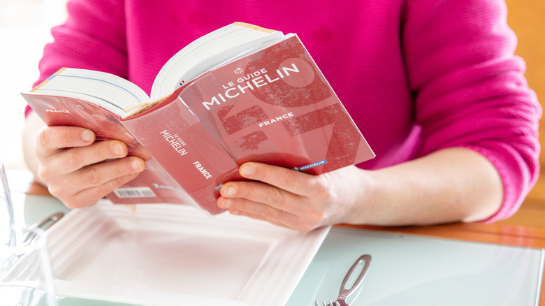 Woman reading Michelin guide