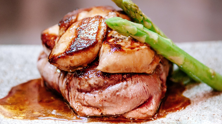 Foie gras on a steak on a white plate