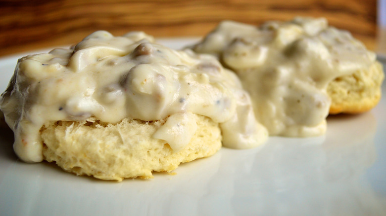biscuits and gravy. on white plate
