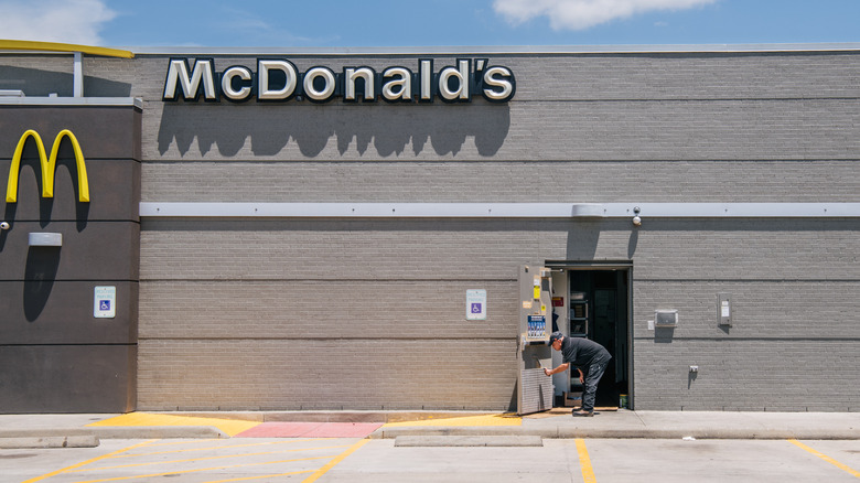 man painting door at McDonald's