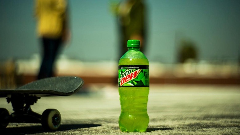 Plastic Mountain Dew bottle next to skateboard