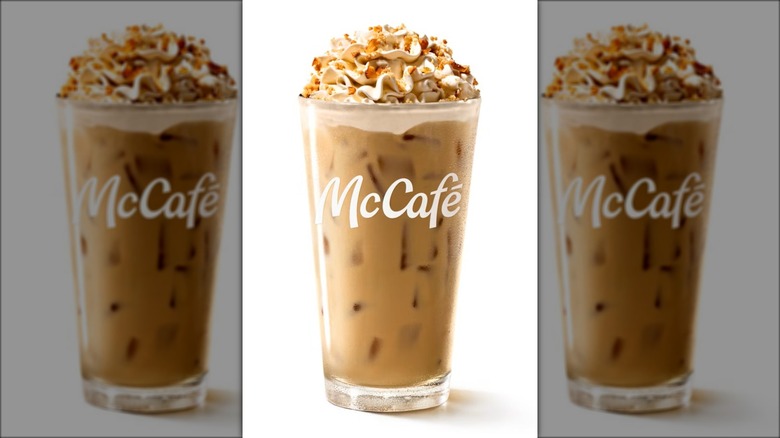 A caramel apple pie coffee from McDonald's in a McCafé glass.