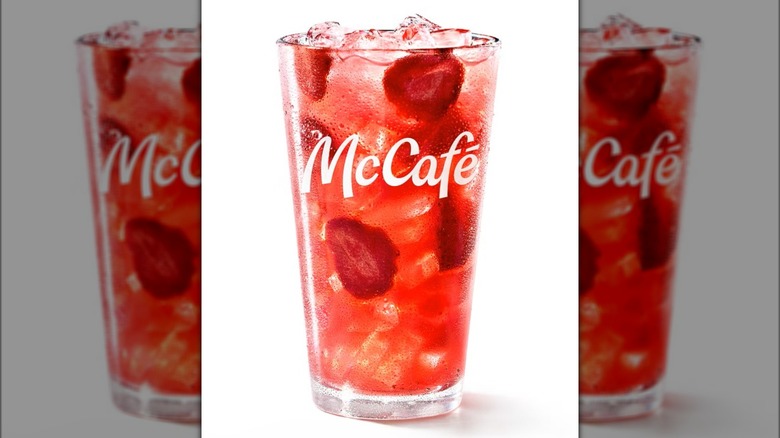 A strawberry watermelon refresher drink from McDonald's in a McCafé glass.