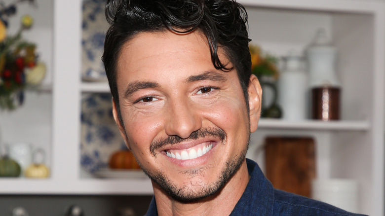 Gabe Bertaccini smiling on kitchen set