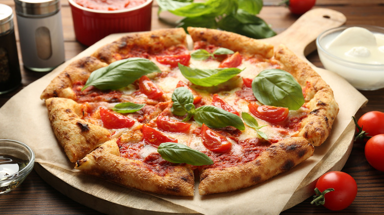 Pizza surrounded by ingredients