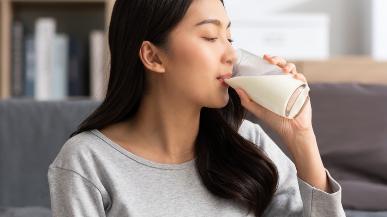 Young woman drinking glass of milk