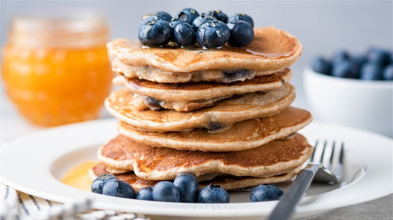 Stacked pancakes topped with blueberries