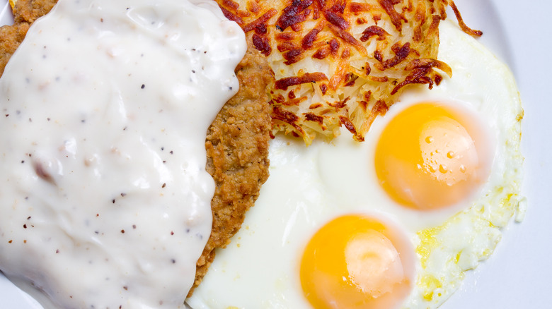 closeup of country fried steak, eggs, and hash browns