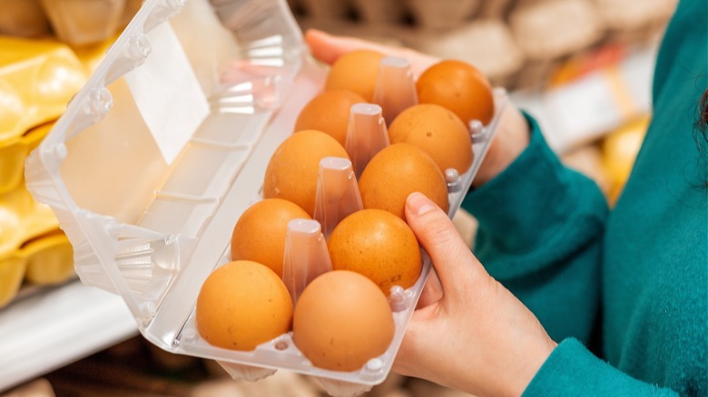 Consumer holding egg carton