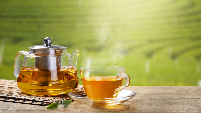 A teapot with a cup of tea