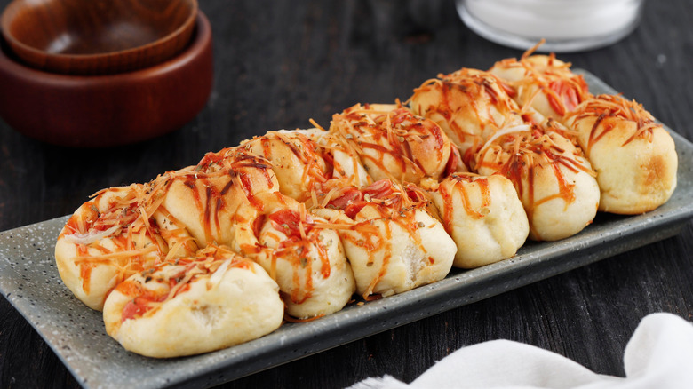 Pull-apart pizza bread on gray plate