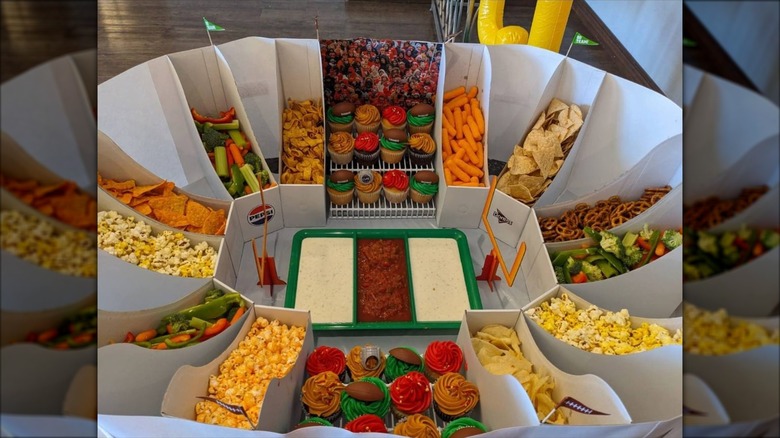 Stadium-style snack tray filled with snack and mini cupcakes