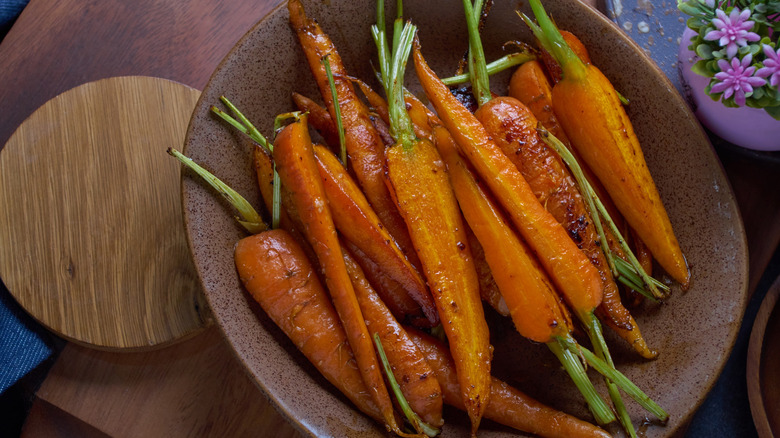 Roasted carrots on wooden plate