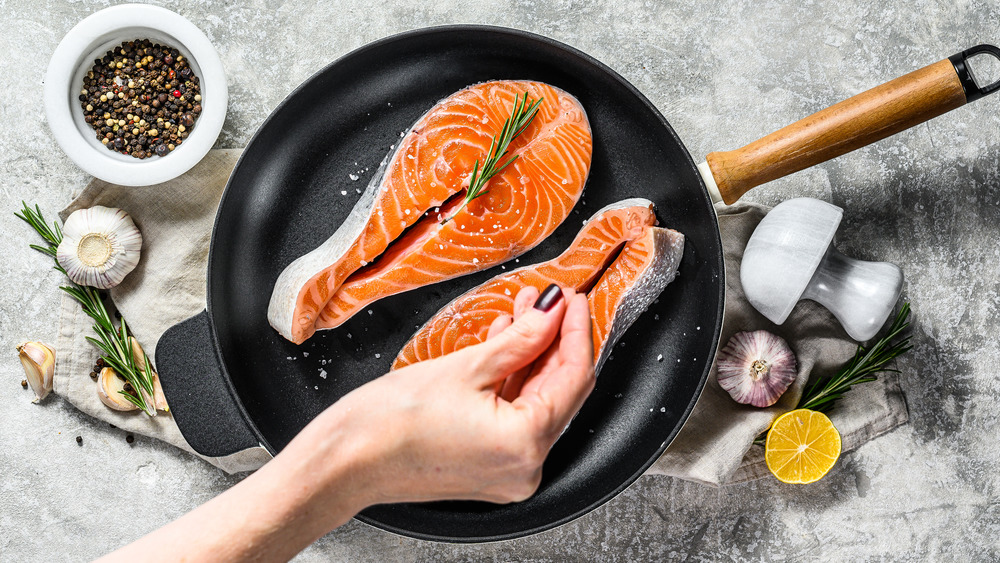 Salmon steak being salted