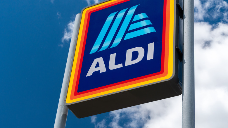 Aldi Store Sign against blue sky with clouds