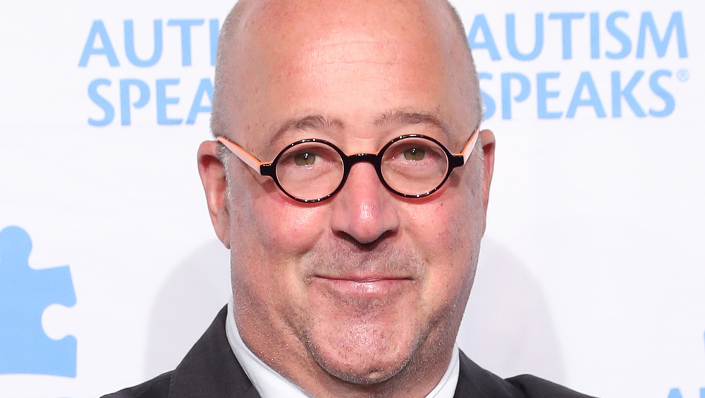 Andrew Zimmern with black and pink glasses
