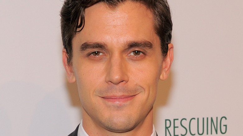 Antoni Porowski smirking