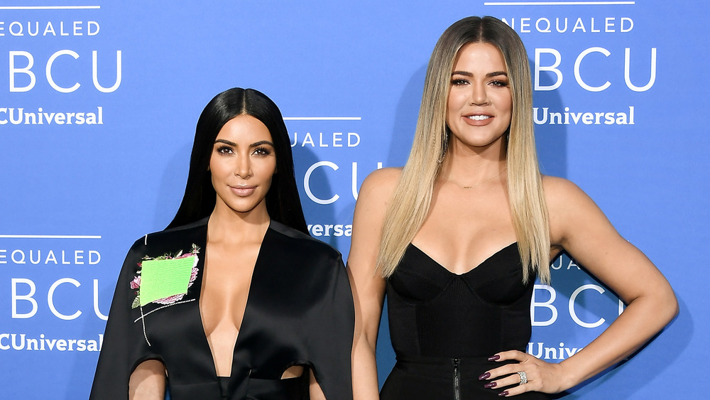Kim and Khloe Kardashian dressed in black