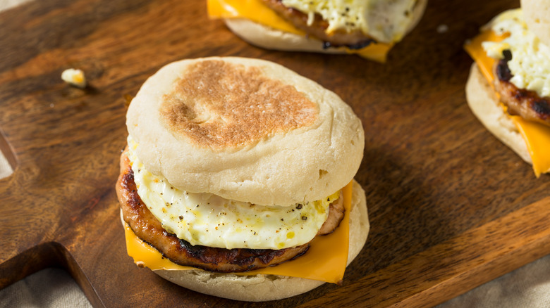 Breakfast sandwiches with egg, sausage, and cheese on English muffins.