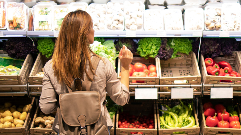 Woman choosing produce at the grocery store