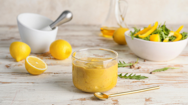 Honey mustard on table with lemons