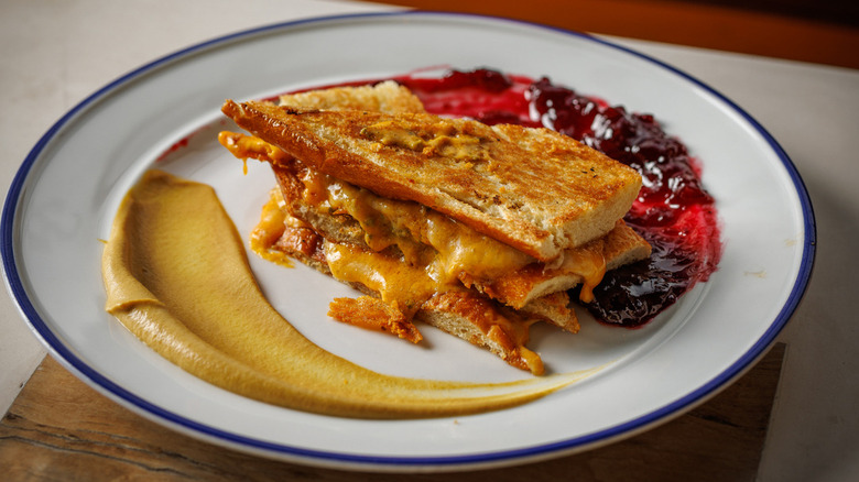 Grilled cheese with jam and Dijon mustard on a plate