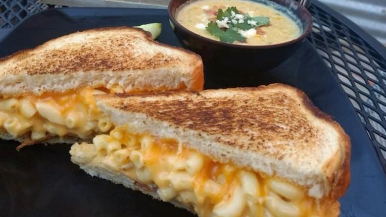 Mac n cheese Grilled cheese split in half and  a bowl of soup