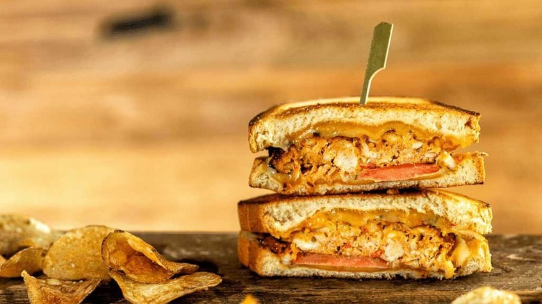 Grilled cheese split in half on a table, one half stacked on top of the other